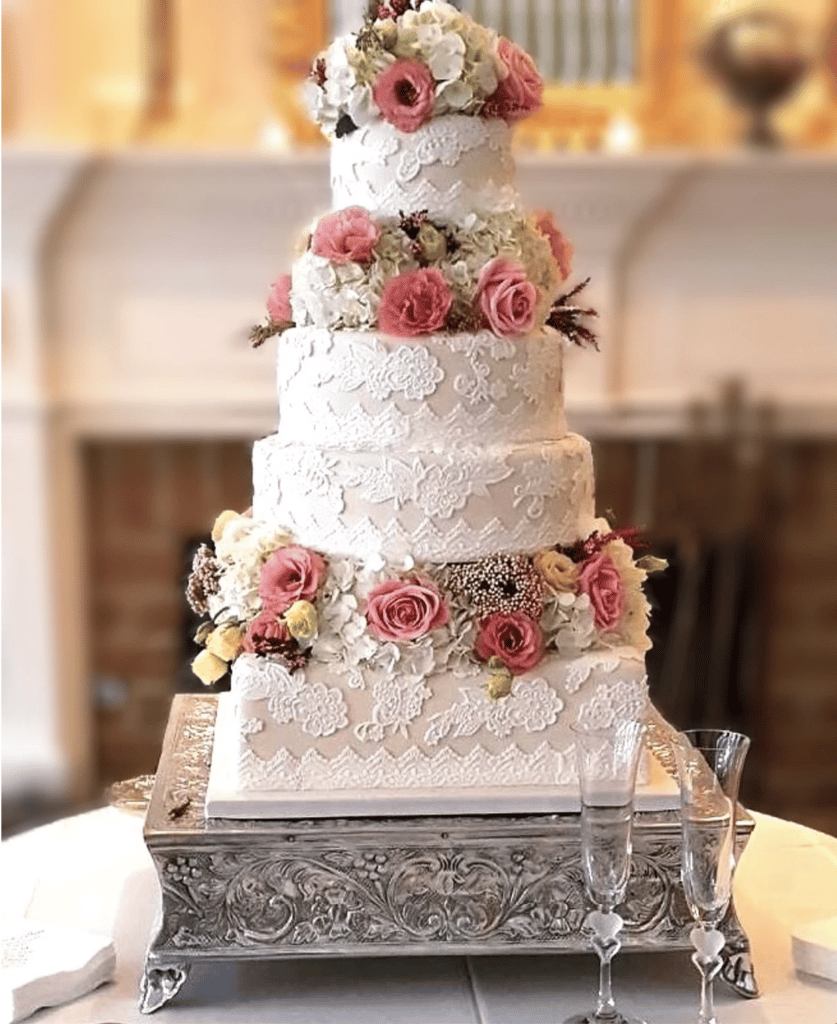wedding cake with florals and lace embellishments